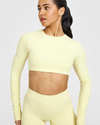 SoftMotion™ Long Sleeve Crop Top with White Logo | Pastel Yellow