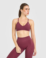 EnhanceLift™ Seamless Strappy Sports Bra with White Logo | Burnt Maroon