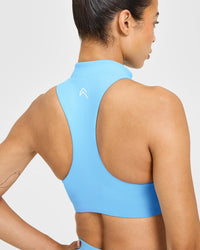 EasyLift™ Zip High Neck Sports Bra with White Logo | Arctic Blue