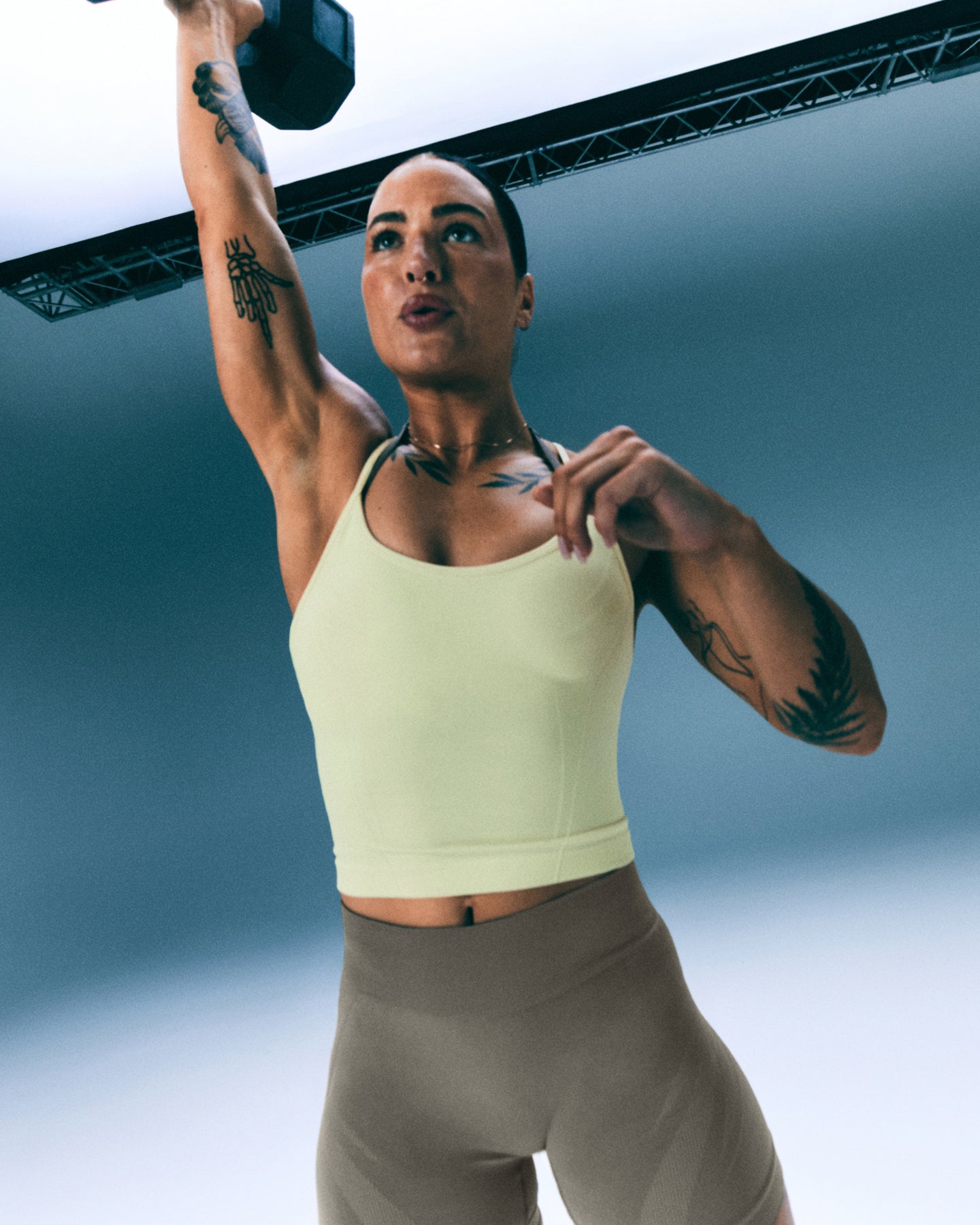 EnhanceLift™ Seamless Strappy Racer Vest with Built in Bra Shelf with Grey Logo | Pastel Yellow