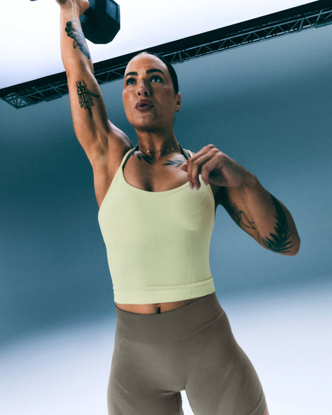 EnhanceLift™ Seamless Strappy Racer Tank Top with Built in Bra Shelf with Grey Logo | Pastel Yellow