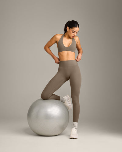 SoftMotion™ Minimal Halter Neck Bralette with Grey Logo | Moss Brown