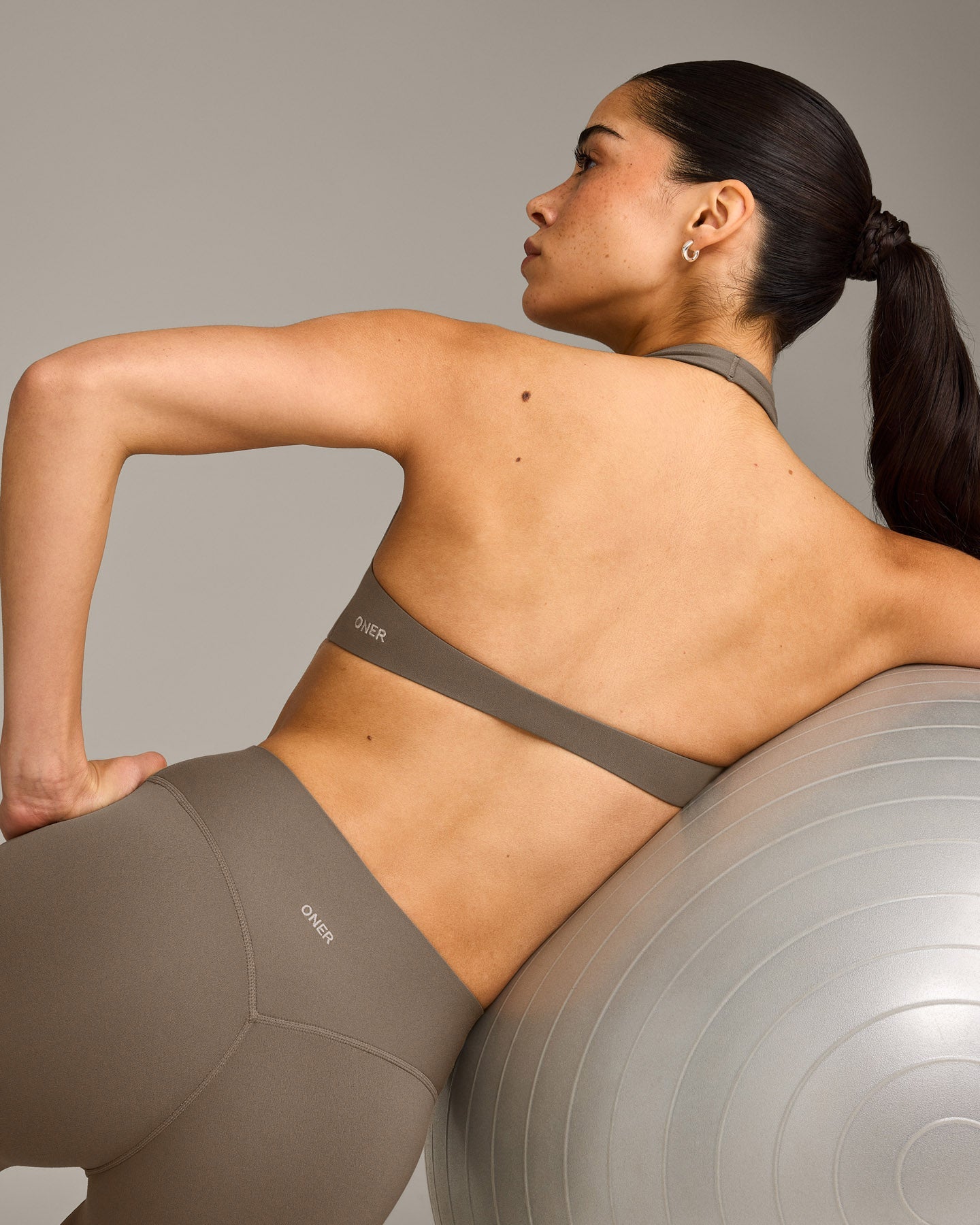 SoftMotion™ Minimal Halter Neck Bralette with Grey Logo | Moss Brown