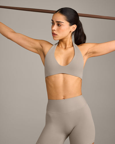 SoftMotion™ Minimal Halter Neck Bralette with White Logo | Warm Sand