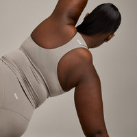 SoftMotion™ Racer Back Mid Vest with Built in Bra Shelf with White Logo | Warm Sand