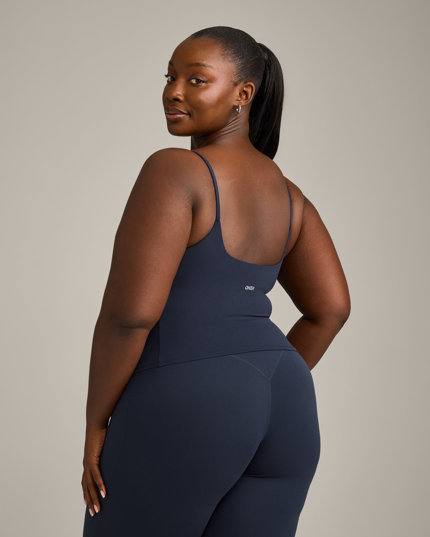 SoftMotion™ Strappy Mid Vest with Built in Bra Shelf with Grey Logo | True Blue