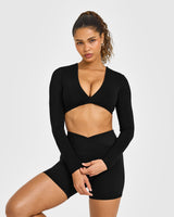 Unified Twist Front Long Sleeve Crop Top White Logo | Black