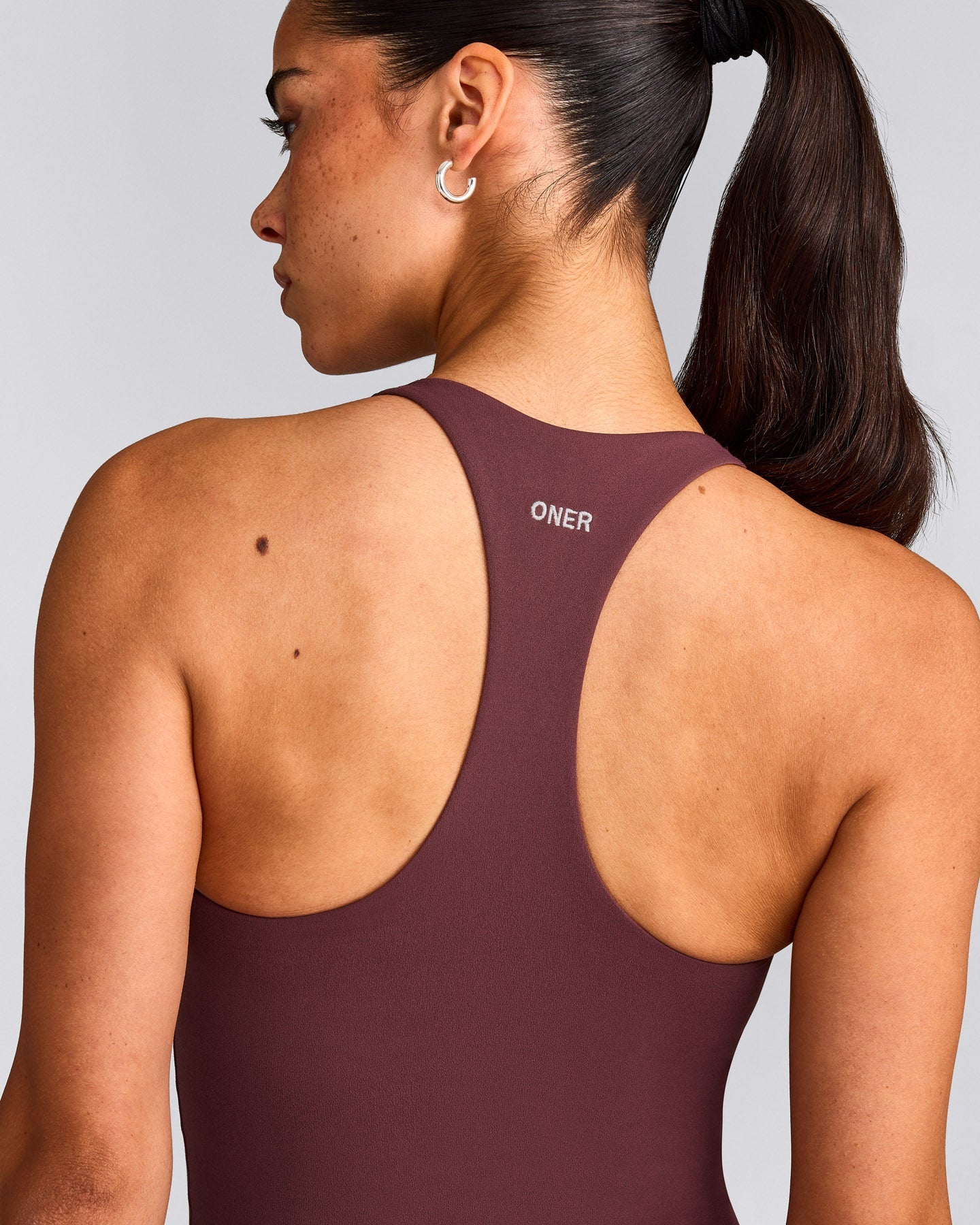 SoftMotion™ Racer Back Mid Tank Top with Built in Bra Shelf with Grey Logo | Velvet Mocha