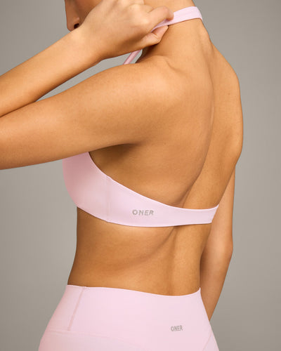 SoftMotion™ Minimal Halter Neck Bralette with Grey Logo | Soft Girl Pink