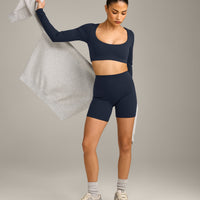 SoftMotion™ Scoop Neck Long Sleeve Crop Top with Built in Bra Shelf with Grey Logo | True Blue