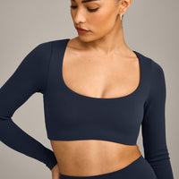 SoftMotion™ Scoop Neck Long Sleeve Crop Top with Built in Bra Shelf with Grey Logo | True Blue