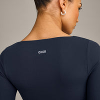 SoftMotion™ Scoop Neck Long Sleeve Crop Top with Built in Bra Shelf with Grey Logo | True Blue