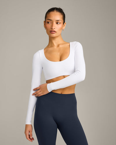 SoftMotion™ Scoop Neck Long Sleeve Crop Top with Built in Bra Shelf with Grey Logo | White