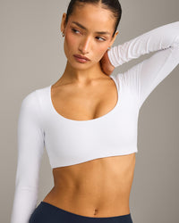 SoftMotion™ Scoop Neck Long Sleeve Crop Top with Built in Bra Shelf with Grey Logo | White