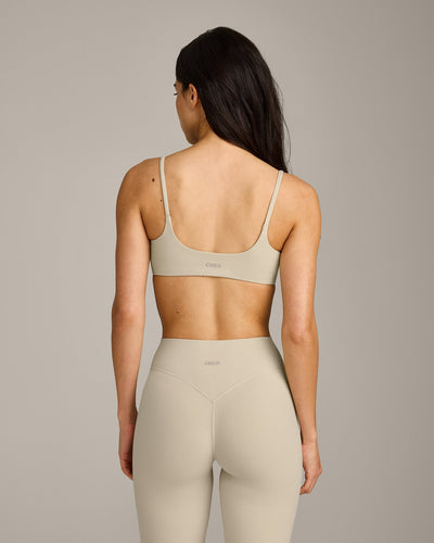 SoftMotion™ Strappy Sports Bra with Grey Logo | Oatmeal