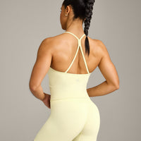 EnhanceLift™ Seamless Strappy Racer Vest with Built in Bra Shelf with Grey Logo | Pastel Yellow
