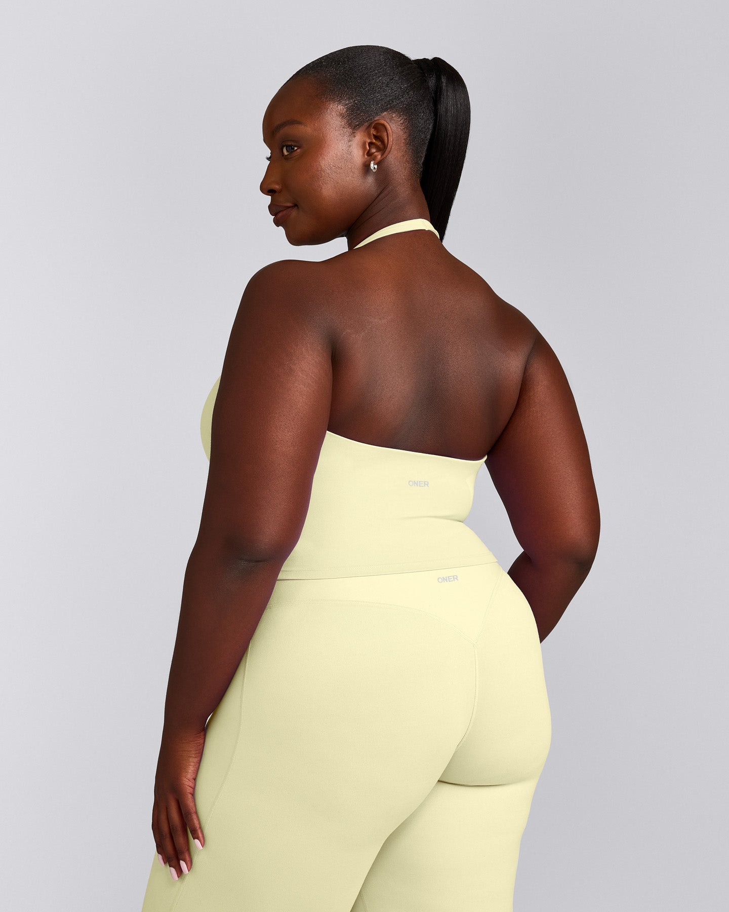 SoftMotion™ Halter Neck Mid Tank Top with Built in Bra Shelf with Grey Logo | Pastel Yellow