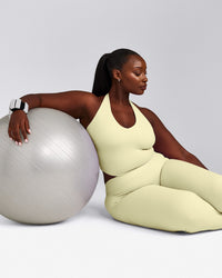 SoftMotion™ Halter Neck Mid Tank Top with Built in Bra Shelf with Grey Logo | Pastel Yellow