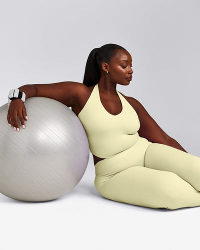 SoftMotion™ Halter Neck Mid Tank Top with Built in Bra Shelf with Grey Logo | Pastel Yellow