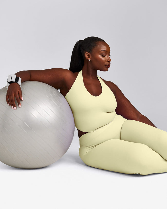 SoftMotion™ Halter Neck Mid Tank Top with Built in Bra Shelf with Grey Logo | Pastel Yellow