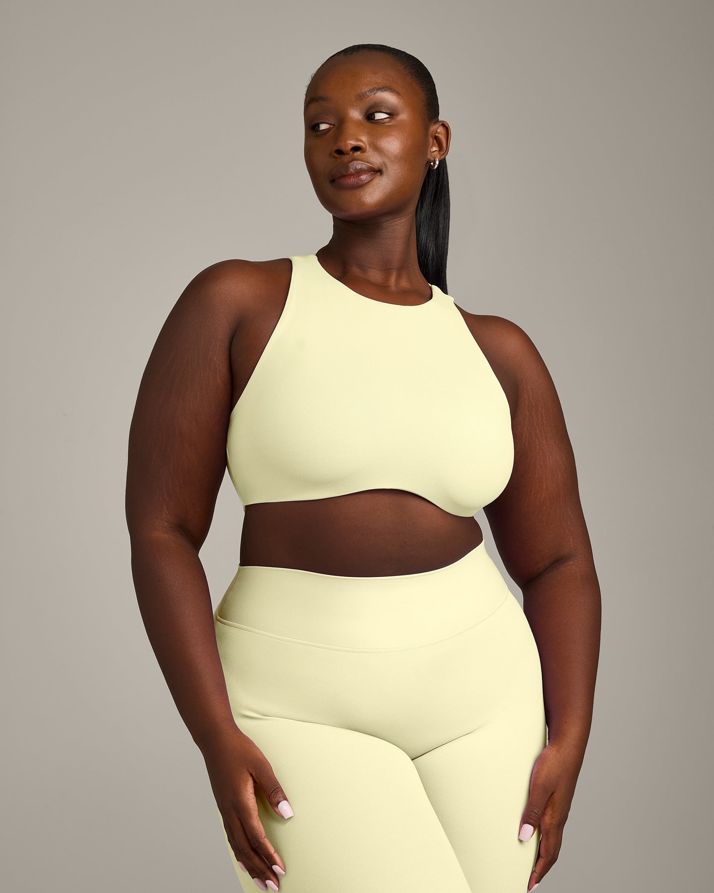 SoftMotion™ High Neck Sports Bra with Grey Logo | Pastel Yellow