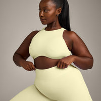 SoftMotion™ High Neck Sports Bra with Grey Logo | Pastel Yellow