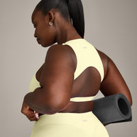 SoftMotion™ High Neck Sports Bra with Grey Logo | Pastel Yellow