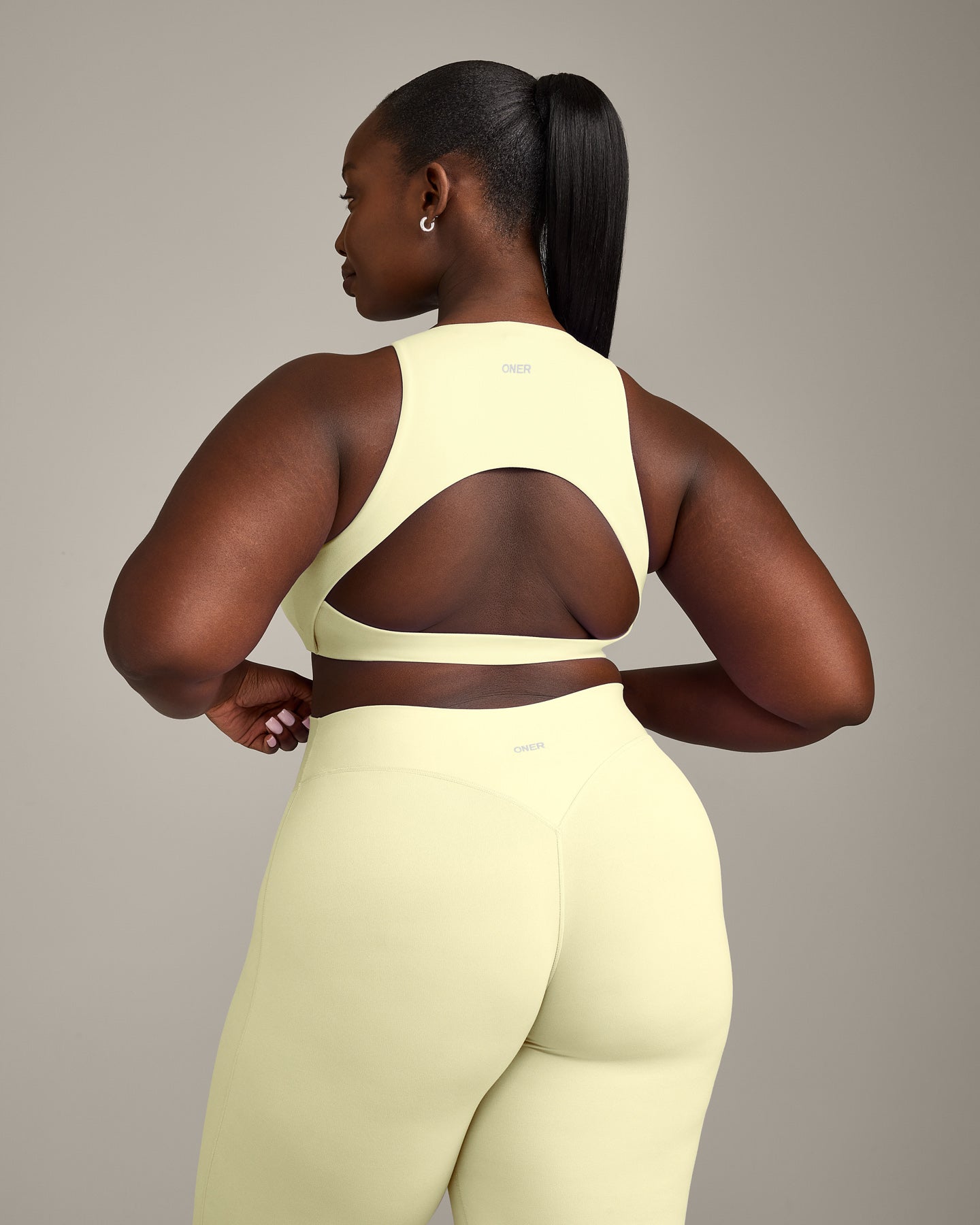 SoftMotion™ High Neck Sports Bra with Grey Logo | Pastel Yellow