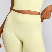 SoftMotion™ Flared Pants with Grey Logo | Pastel Yellow