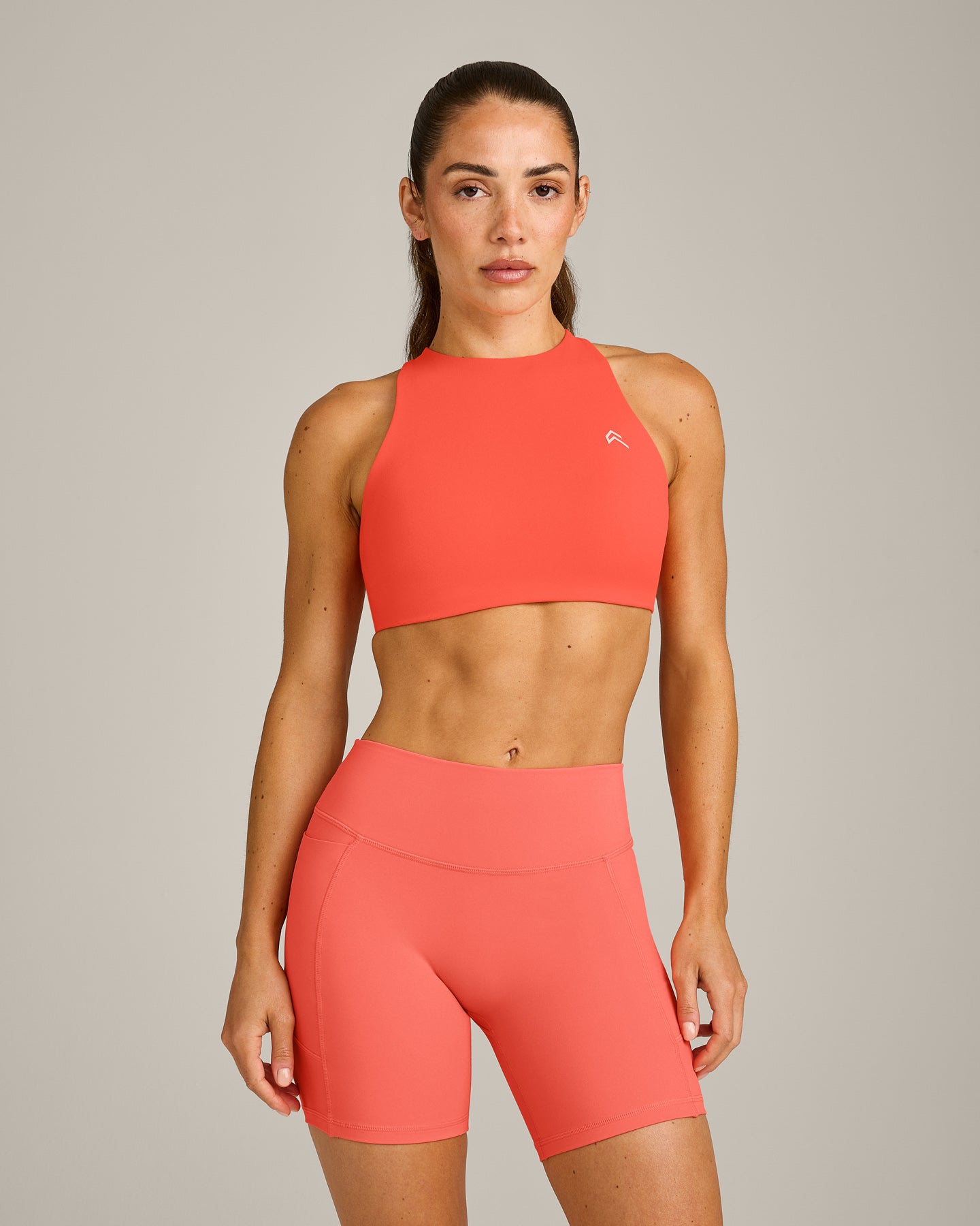 EasyLift™ High Neck Sports Bra with Grey Logo | Hyper Orange
