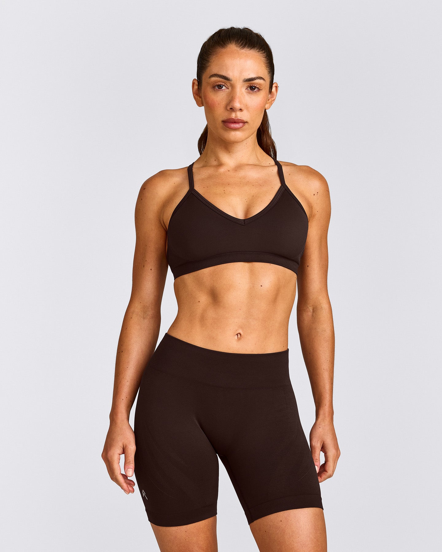 EnhanceLift™ Seamless Strappy Sports Bra with Grey Logo | 70% Cocoa