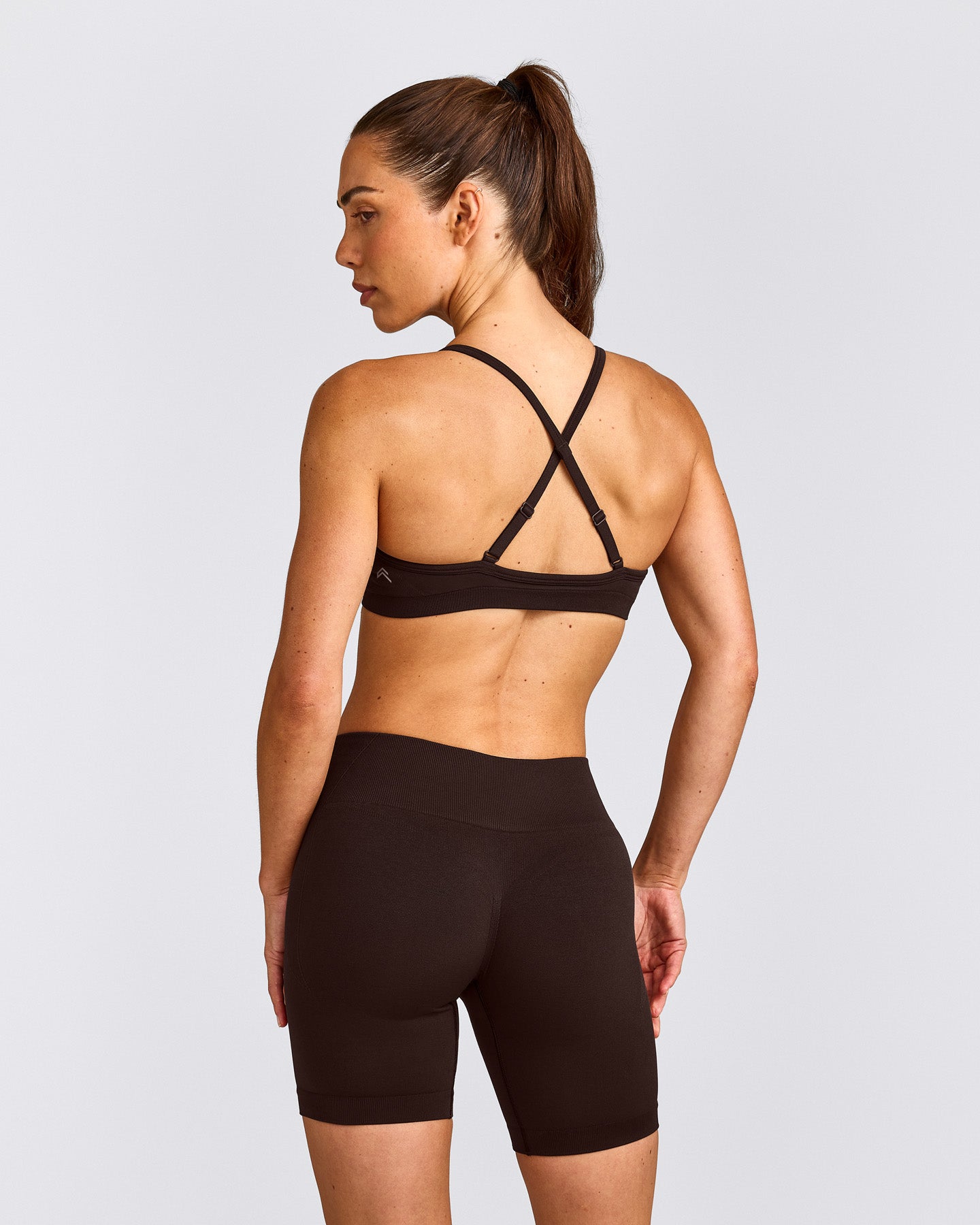 EnhanceLift™ Seamless Strappy Sports Bra with Grey Logo | 70% Cocoa
