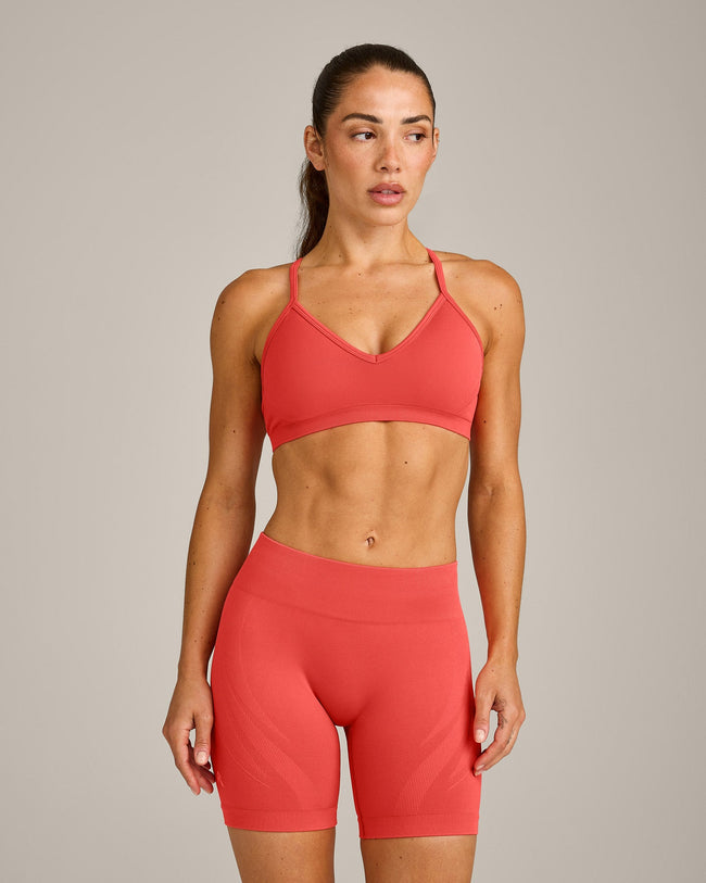 EnhanceLift™ Seamless Strappy Sports Bra with Grey Logo | Dark Charged Coral