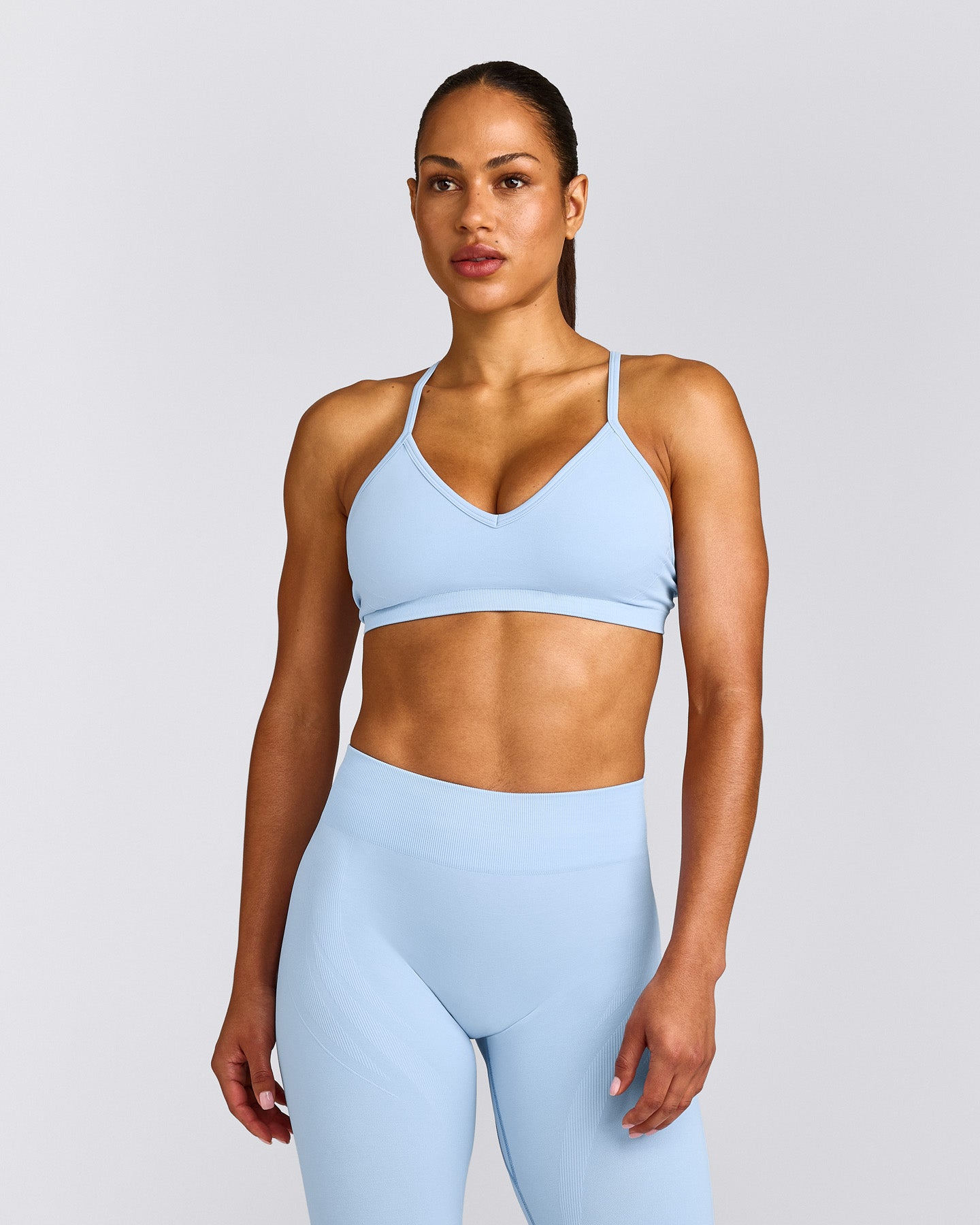 EnhanceLift™ Seamless Strappy Sports Bra with Grey Logo | Powdered Blue