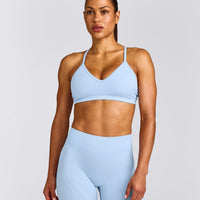 EnhanceLift™ Seamless Strappy Sports Bra with Grey Logo | Powdered Blue