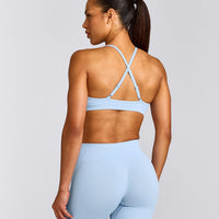 EnhanceLift™ Seamless Strappy Sports Bra with Grey Logo | Powdered Blue