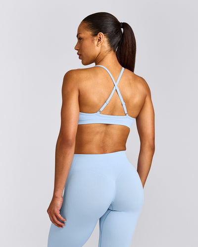 EnhanceLift™ Seamless Strappy Sports Bra with Grey Logo | Powdered Blue