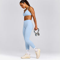 EnhanceLift™ Seamless Strappy Sports Bra with Grey Logo | Powdered Blue