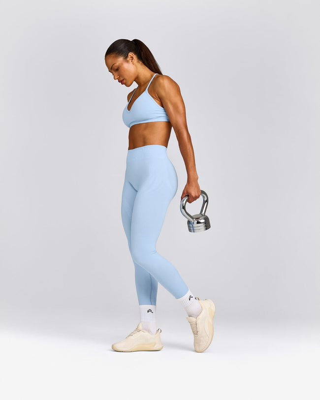 EnhanceLift™ Seamless Strappy Sports Bra with Grey Logo | Powdered Blue