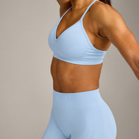 EnhanceLift™ Seamless Strappy Sports Bra with Grey Logo | Powdered Blue