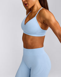 EnhanceLift™ Seamless Strappy Sports Bra with Grey Logo | Powdered Blue