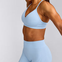 EnhanceLift™ Seamless Strappy Sports Bra with Grey Logo | Powdered Blue