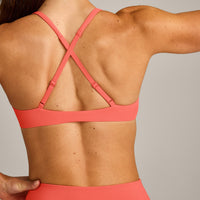 UnifiedMove™ Cross Back Sports Bra with Reflective Logo | Light Charged Coral
