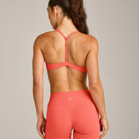 UnifiedMove™ T Back Minimal Bralette with Reflective Logo | Light Charged Coral
