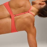 UnifiedMove™ T Back Minimal Bralette with Reflective Logo | Light Charged Coral