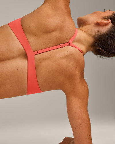 UnifiedMove™ T Back Minimal Bralette with Reflective Logo | Light Charged Coral